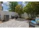 Paver patio in backyard offers outdoor seating and shade trees providing comfortable outdoor relaxation at 9520 Trumpet Vine Loop, Trinity, FL 34655