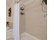 Bright bathroom features tile walls, an open shower and a soaking tub with elegant fixtures at 9520 Trumpet Vine Loop, Trinity, FL 34655