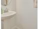 Cozy bathroom features a pedestal sink and tiled flooring and neutral wall color at 9520 Trumpet Vine Loop, Trinity, FL 34655