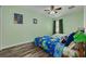 Fun bedroom featuring brightly colored walls and bedding, as well as wood look floors at 9520 Trumpet Vine Loop, Trinity, FL 34655