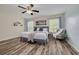 Bright bedroom with hardwood floors, a ceiling fan and large windows with natural light at 9520 Trumpet Vine Loop, Trinity, FL 34655