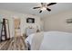 This bedroom features a neutral color palette and wood flooring, offering a comfortable retreat at 9520 Trumpet Vine Loop, Trinity, FL 34655