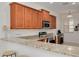 Stylish kitchen featuring granite countertops, stainless steel appliances, breakfast bar, and ample cabinet space at 9520 Trumpet Vine Loop, Trinity, FL 34655