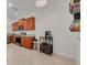 Open kitchen area with tile floors, granite counters, wood cabinets, and stainless steel appliances at 9520 Trumpet Vine Loop, Trinity, FL 34655