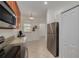 Well-lit kitchen features stainless steel appliances, wood cabinetry, and tiled flooring at 9520 Trumpet Vine Loop, Trinity, FL 34655