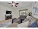 Comfortable living room with a large sectional, ceiling fan, tile flooring, and view to exterior at 9520 Trumpet Vine Loop, Trinity, FL 34655