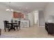 Open-concept living and dining area with tile floors and seamless flow to the kitchen and staircase at 9520 Trumpet Vine Loop, Trinity, FL 34655