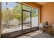 Enclosed patio provides serene outdoor living with brick flooring, patio furniture, and screened windows at 9520 Trumpet Vine Loop, Trinity, FL 34655