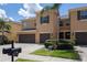 Inviting townhome with a two-car garage, manicured lawn, and a charming palm tree in a well maintained community at 9520 Trumpet Vine Loop, Trinity, FL 34655
