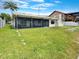 This home features a spacious backyard, an airy screened-in lanai and a grassy yard, great for entertaining at 9907 Island Harbor Dr, Port Richey, FL 34668