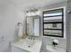 Updated bathroom featuring modern vanity, sleek mirror, and great natural light at 9907 Island Harbor Dr, Port Richey, FL 34668