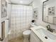 Cozy bathroom with shower, tile floors, framed artwork and a modern vanity at 9907 Island Harbor Dr, Port Richey, FL 34668