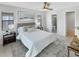 Inviting bedroom with a cozy bed, modern decor, and a view into the bathroom at 9907 Island Harbor Dr, Port Richey, FL 34668