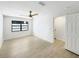 This spacious bedroom has a ceiling fan, tile floors and a large window for natural light at 9907 Island Harbor Dr, Port Richey, FL 34668
