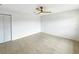 This spacious bedroom has a ceiling fan, tile floors and a closet at 9907 Island Harbor Dr, Port Richey, FL 34668