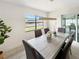 Bright dining area featuring a modern wooden table with seating for six, and water view at 9907 Island Harbor Dr, Port Richey, FL 34668