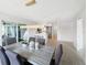 Open dining space with modern light fixture and seating, flowing into the kitchen at 9907 Island Harbor Dr, Port Richey, FL 34668