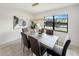 Beautiful dining room with waterfront views from large windows and modern furnishings at 9907 Island Harbor Dr, Port Richey, FL 34668