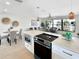 Open concept kitchen with an island cooktop, connecting the dining and living spaces at 9907 Island Harbor Dr, Port Richey, FL 34668