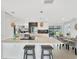Modern kitchen featuring an island with seating, stainless steel appliances, and stylish light fixtures at 9907 Island Harbor Dr, Port Richey, FL 34668
