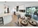 Modern kitchen featuring white cabinets, a cooktop island, and an adjacent dining area at 9907 Island Harbor Dr, Port Richey, FL 34668