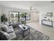 Cozy living room featuring a large window, plush seating, stylish decor, and modern finishes at 9907 Island Harbor Dr, Port Richey, FL 34668