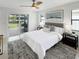 Bright main bedroom with ample light, ceiling fan, and large sliding glass doors to lanai at 9907 Island Harbor Dr, Port Richey, FL 34668