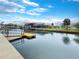 Waterfront view with boat dock and lovely scenery, offering serene living and boating opportunities at 9907 Island Harbor Dr, Port Richey, FL 34668