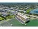 Aerial view showcasing the condo building, community pool, and waterfront location, highlighting property's amenities at 100 Bluff View Dr # 405A, Belleair Bluffs, FL 33770