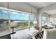Bright, large office featuring a modern desk, neutral decor, and large windows with neighborhood views at 100 Bluff View Dr # 405A, Belleair Bluffs, FL 33770