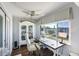 Charming home office with built-in shelving, desk, and a window offering natural light and neighborhood views at 100 Bluff View Dr # 405A, Belleair Bluffs, FL 33770