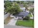 Aerial view of a charming home with a well-manicured lawn and a fenced backyard at 1011 N Paddock Ave, Tampa, FL 33607