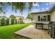 Spacious backyard featuring a shed, lush lawn, patio area, and a grilling area at 1011 N Paddock Ave, Tampa, FL 33607