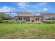 A screened-in backyard featuring well-maintained lawn and landscaping around the home's perimeter at 10415 Cardera Dr, Riverview, FL 33578