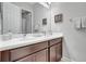 Bathroom with dual sinks, a large mirror, and modern fixtures at 10415 Cardera Dr, Riverview, FL 33578