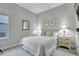 Neutral bedroom with a comfortable bed, side tables with lamps, and soft carpeting at 10415 Cardera Dr, Riverview, FL 33578