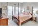 Bedroom with four poster bed, carpet flooring, and bright natural light at 10415 Cardera Dr, Riverview, FL 33578