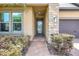 Inviting front entrance with stone accents, a decorative glass door, and manicured landscaping at 10415 Cardera Dr, Riverview, FL 33578