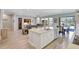 Bright kitchen with a large island, stainless steel appliances, and a view of the living area and the pool at 10415 Cardera Dr, Riverview, FL 33578