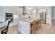 Bright kitchen featuring white cabinets, a large island with seating, and stainless steel appliances at 10415 Cardera Dr, Riverview, FL 33578