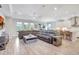 Open-concept living room with a large sectional sofa, and bright windows at 10415 Cardera Dr, Riverview, FL 33578