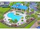 A beautiful community pool with a covered pavilion, palm trees, ample lounge chairs, and surrounding green space at 10415 Cardera Dr, Riverview, FL 33578
