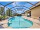 Sparkling screened-in pool with sun-drenched patio area, perfect for relaxation and outdoor entertainment at 10415 Cardera Dr, Riverview, FL 33578