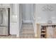 A staircase is located next to a stainless steel refrigerator and light wood cabinet in this home at 10415 Cardera Dr, Riverview, FL 33578