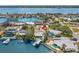 Picturesque aerial view of a waterfront property with a pool, dock, and lush tropical landscaping at 106 Midway Is, Clearwater Beach, FL 33767