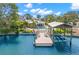 Aerial view showcasing the home's private dock, boat lift, and pool overlooking the water at 106 Midway Is, Clearwater Beach, FL 33767