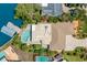 Overhead view of the property with a sparkling pool and canal, surrounded by mature landscaping at 106 Midway Is, Clearwater Beach, FL 33767
