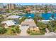 Stunning aerial view showcases the property, surrounded by lush greenery and waterfront access at 106 Midway Is, Clearwater Beach, FL 33767