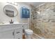 Renovated bathroom featuring a glass-enclosed shower and custom vanity at 106 Midway Is, Clearwater Beach, FL 33767