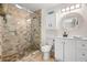 Elegant bathroom with a glass shower, vanity, and natural stone accents at 106 Midway Is, Clearwater Beach, FL 33767